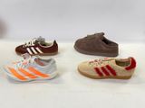 several pairs of shoes are lined up in a row on a white surface