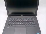 a laptop with a black keyboard on a white surface