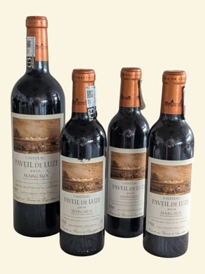 four bottles of wine are lined up in a row