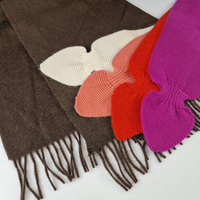 several different colored scarves are laid out on a white surface