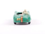 a green toy car with two dogs in it
