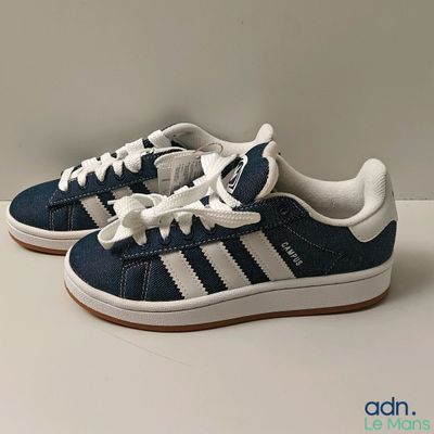 a pair of blue and white sneakers on a white surface