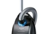 the black and blue vacuum is sitting on a white surface