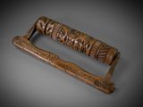 a close up of a wooden handle with carvings on it