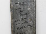 a piece of metal with writing on it