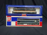 two boxed boxes of toy trains sitting on a black surface
