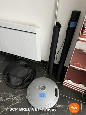 a vacuum cleaner sitting on the floor next to a bag
