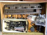 a box full of assorted train parts in it