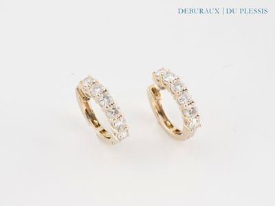 une paire de boucles d'oreilles en diamant sur fond blanc