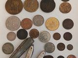 a lot of coins and a pocket knife on the table