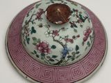 a plate with a lid that has a flower design on it