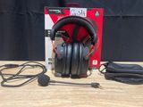 a close up of a pair of headphones sitting on top of a wooden table