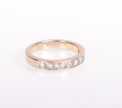 a close up of a diamond ring on a white surface