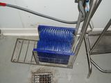 a picture of a sink with a blue bucket and a drain