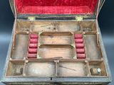 an old wooden box with a bunch of red items inside of it