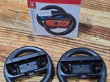 two nintendo wii controllers sitting on top of a table next to a box