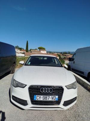 an audi car parked in a parking lot next to a van