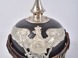 an image of a black and silver military helmet with a silver eagle on it