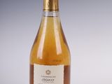 bottles of wine are lined up on a white surface