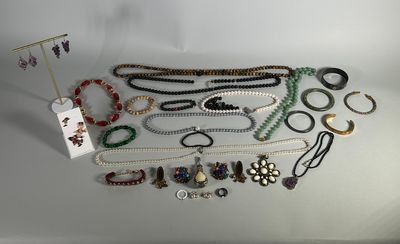 a group of assorted necklaces and bracelets on a table