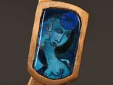 a picture of a woman in a mirror on a wooden stick