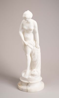white marble statue of a woman holding a bag