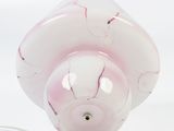 a white and pink lamp that is on a white surface