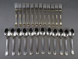a lot of silver spoons and forks on the table