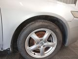 a close up of a tire on a car in a garage