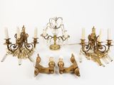 several brass and crystal chandeliers are arranged on a white surface