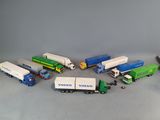 several toy trucks are lined up in a circle on a gray surface