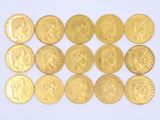 gold coins of various sizes and shapes on a white surface