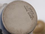 a close up of a bottle of wine with a cork in the background