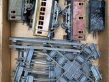a box full of toy train tracks and other toy trains