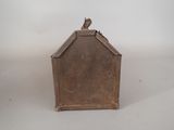 a small metal box with a bird on top of it