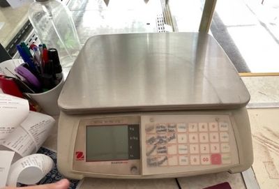 a scale that is sitting on a counter with a calculator in front of it