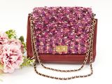 pink and brown tweed purse with chain and flowers on a white background