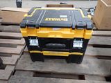a yellow and black tool box sitting on a pallet
