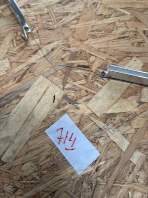 a pair of scissors on the floor next to a piece of paper