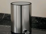 a trash can sitting on a marble counter top