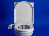 a white toilet with the lid up against a blue background