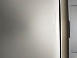 a white refrigerator and a silver refrigerator freezer next to each other