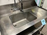 a stainless steel sink in the middle of a kitchen
