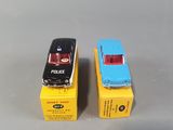 two toy cars sitting next to each other on a table