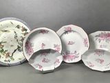several plates and bowls are sitting on a gray surface