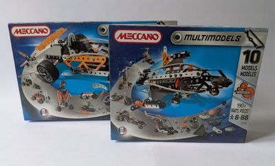 two boxed boxes of legos with a helicopter and a boat in them