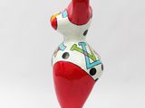 a close up of a sculpture of a bird on a stand
