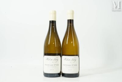 two bottles of white wine sitting next to each other on a white surface