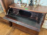 a wooden desk with a drawer underneath it on a hard wood floor