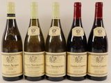six bottles of wine are lined up in a row on a table